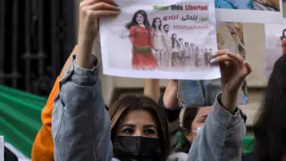 A woman hold a sign during a solidarity rally following the death of Iranian Mahsa Amini, who died last week in Iran after being arrested by morality police, in Santiago