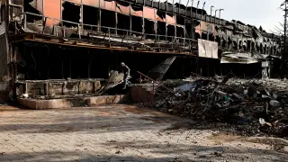 A local resident walks past a destroyed building, amid Russia's attack on Ukraine in Bakhmut