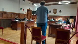 El acusado, de pie, durante su declaración este martes en el juicio celebrado en la Audiencia de Teruel.