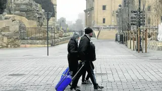 Varios turistas, ayer, con sus maletas por el centro de Zaragoza
