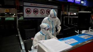 FILE PHOTO: Airline staff wear personal protective equipment to protect against COVID-19, in Beijing