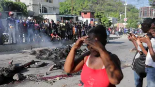 Alleged gang members set on fire by crowd of people, in Port-au-Prince