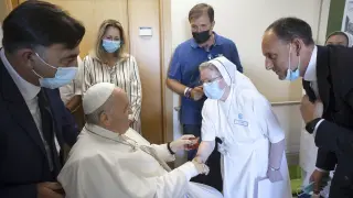 FILE-- Pope Francis is greeted by a nun as he sits in a wheelchair inside the Agostino Gemelli University Polyclinic in Rome, Sunday, July 11, 2021, where he was hospitalized for intestine surgery. The Vatican said Francis, 86, would be put under general anesthesia for the procedure Wednesday afternoon, June 07, 2023, and would be hospitalized at Rome's Gemelli hospital for several days. (Vatican Media via AP)