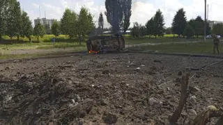 View of an overturned car and projectile crater after dozens, including children, were wounded by a Russian military strike in Pervomaiskyi, amid Russia's attack on Ukraine, in Kharkiv region, Ukraine July 4, 2023 in this image obtained from social media. Telegram/Kharkiv Region Governor Oleg Synegubov via REUTERS ATTENTION EDITORS - THIS IMAGE HAS BEEN SUPPLIED BY A THIRD PARTY. MANDATORY CREDIT. NO RESALES. NO ARCHIVES. BEST QUALITY AVAILABLE