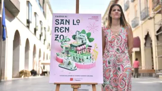 Ana Porta junto al cartel que ha diseñado para las Fiestas de San Lorenzo 2023.