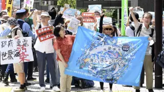Protester holds a sign during a rally against the treated radioactive water release from the damaged Fukushima nuclear power plant, in front of Tokyo Electric Power Company Holdings (TEPCO) headquarters, Thursday, Aug. 24, 2023, in Tokyo. The operator of the tsunami-wrecked Fukushima Daiichi nuclear power plant will begin releasing the first batch of treated and diluted radioactive wastewater into the Pacific Ocean later Thursday, utility executives said.(AP Photo/Norihiro Haruta) LaPresse Only italy and Spain