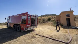 Un bombero descarga la cisterna en el depósito de agua de Bádenas, municipio en la comarca del Jiloca (Teruel)