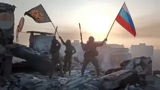 FILE - In this image from video provided by Prigozhin Press Service on Saturday, May 20, 2023, Yevgeny Prigozhin's Wagner Group military company members wave a Russian national and Wagner flag atop a damaged building in Bakhmut, Ukraine. Yevgeny Prigozhin's armed revolt against Russia's military leadership posed the greatest challenge to Vladimir Putin's authorities in his 23-year rule. (Prigozhin Press Service via AP, File)