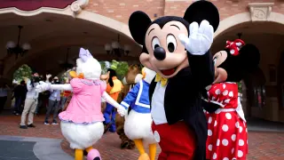 FILE PHOTO: Disney character Mickey Mouse greets visitors at Shanghai Disney Resort as the Shanghai Disneyland theme park reopens following a shutdown due to the coronavirus disease (COVID-19) outbreak, in Shanghai