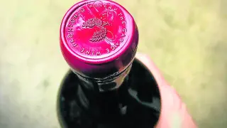 Detalle de una botella rematada con lacre y, en este caso, también con un sello estampado.