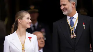 Princess Leonor looks at her father, the Spanish King Felipe VI, as they attend a military parade after swearing allegiance to the Constitution during a gala event that makes her eligible to be queen one day, in Madrid on Tuesday, Oct. 31 2023. The heir to the Spanish throne, Princess Leonor has sworn allegiance to the Constitution on her 18th birthday. Tuesday's gala event paves the way to her becoming queen when the time comes. Leonor is the eldest daughter of King Felipe and Queen Letizia. (AP Photo/Manu Fernandez)