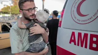 November 5, 2023: Deir Al-Balah, Gaza Strip, Palestine. 05 November 2023. A father holds his toddler injured in Israeli raids on the Al-Bureij refugee camp in the Deir Al-Balah governorate, outside the Al-Aqsa Martyrs Ho