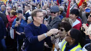 Feijoo saluda a algunos manifestantes al inicio de la marcha en Madrid.