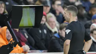 Referee David Coote checks VAR screen during the English Premier League soccer match between Brentford and Aston Villa, at the Gtech Community Stadium in London, Sunday, Dec. 17, 2023. (AP Photo/Dave Shopland)