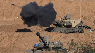 An Israeli self-propelled artillery unit fires as seen from southern Israel