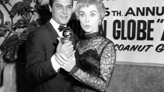 Tony Curtis holds his Golden Globe award for World Male Film Favorite as his wife, actress Janet Leigh, gives a look of surprise at the Hollywood Foreign Press Association awards dinner at the Coconut Grove in Hollywood, Calif., Feb. 26, 1958. Curtis was nominated, but did not win, in the best actor category for "The Defiant Ones," which won best picture. (AP Photo)