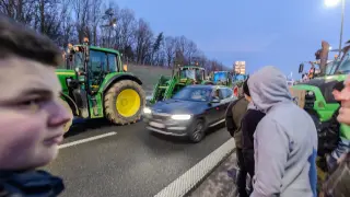 Cars passing on one single way near tractors at a farmers protest on the border of Belgium and France, between Aubange (B) and Mont-Saint-Martin (Fr), Monday 29 January 2024. Farmers protests accross Europe are growing as they demand better conditions to grow produce and maintain a proper income...29/01/2024 [[[EP]]]