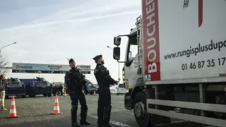 Policías franceses patrullan la entrada de la ciudad de Rungis, cerca de París, ante las protestas de los agricultores.