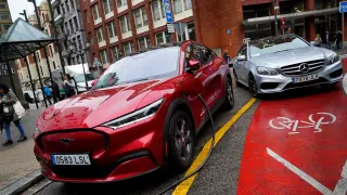 FILE PHOTO: A Ford Mustang Mach-e electric vehicle is seen plugged into a charging station in Bilbao