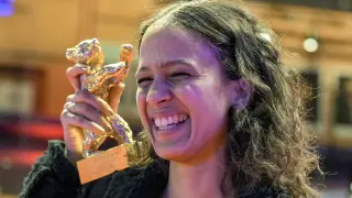 Director Mati Diop displays the Golden Bear she received for her documentary "Dahomey" at the International Film Festival, Berlinale, in Berlin, Saturday, Feb. 24, 2024. (AP Photo/Markus Schreiber)