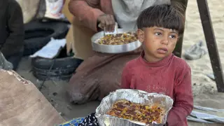 Un niño come un plato del Iftar, que marca la ruptura del ayuno en ramadán en Rafah, Gaza.