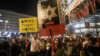 March 30, 2024, Tel Aviv, Israel: An Israeli protestors hold up a placard with the Star of David made from the Israeli hostage's photos painted with red. Tens of thousands of people demonstrated with the hostages families against Prime Minister Benjamin Netanyahu in Tel Aviv, demanding an immediate hostage deal. Clashes with the Israeli police occurred after protestors had set up a few bonfires and blocked the Ayalon highway later dispersed by police water cannons. (Credit Image: © Matan Golan/SOPA Images via ZUMA Press Wire)