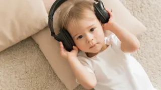 top-view-cute-baby-wearing-headphones