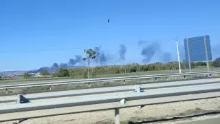 El humo del incendio en la chatarrería visto desde la carretera