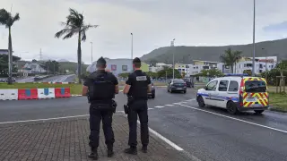 FILE - French gendarme patrol at a roundabout in Noumea, New Caledonia, Sunday Dec.12, 2021. At least two people were killed and three were seriously injured overnight in the French Pacific territory of New Caledonia, French officials there said Wednesday, May 15, 2024, as President Emmanuel Macron convened a meeting of top ministers to discuss the spiraling violence. (AP Photo/Clotilde Richalet, File)