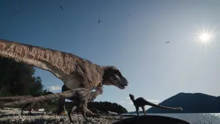 Fotografía cedida por Giant Screen Films donde aparece una madre Tiranousario Rex y sus crías junto a un lago