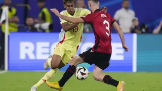 Spain's Lamine Yamal, left, vies for the ball with Albania's Mario Mitaj during a Group B match between Albania and Spain at the Euro 2024 soccer tournament in Duesseldorf, Germany, Monday, June 24, 2024. Spain won 1-0. (AP Photo/Manu Fernandez)