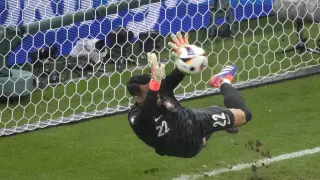 Portugal's goalkeeper Diogo Costa saves the ball during penalties of a round of sixteen match between Portugal and Slovenia at the Euro 2024 soccer tournament in Frankfurt, Germany, Monday, July 1, 2024. (AP Photo/Michael Probst)