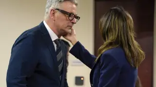Actor Alec Baldwin approaches his wife Hilaria during his trial, Thursday, July 11, 2024, in Santa Fe, N.M. Baldwin is charged with involuntary manslaughter in the 2021 fatal shooting of cinematographer Halyna Hutchins during filming of the Western movie "Rust". (Ramsay de Give/Pool Photo via AP)