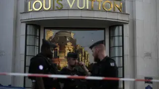 Police officers stand guard at the Louis Vuitton store on the Champs-Elysees avenue, after a stabbing Thursday, July 18, 2024 in Paris. French Interior Minister Gerald Darmanin said a police officer was attacked in Paris on Thursday in the Champs-Elysees neighborhood and the assailant was immediately "neutralized," just days before the opening ceremony of the Summer Olympics. (AP Photo/David Goldman)