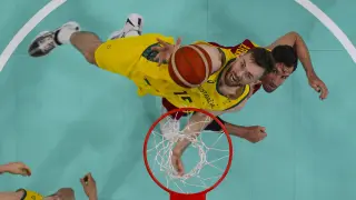 Nick Kay, of Australia, shoots over Rudy Fernández, of Spain, during a men's basketball game at the 2024 Summer Olympics, Saturday, July 27, 2024, in Lille, France. (Brian Snyder/Pool Photo via AP)