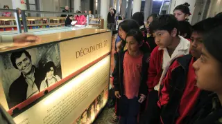FILE - Students learn about Peruvian writer Mario Vargas Llosa at a public library in Lima, Peru, Oct. 7, 2010. (AP Photo/Martin Mejia, File)
