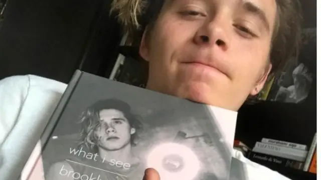Brooklyn Beckham, con su libro, en una foto de su cuenta de Instagram.