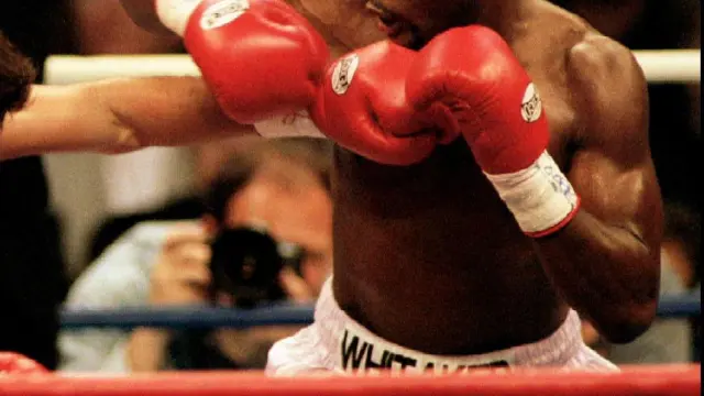 FILE PHOTO: Oscar De La Hoya (L) lands a punch to the body of Pernell Whitaker during their WBC Welterweight Championship fight in Las Vegas, April 12 1997. De La Hoya won the 12 round bout by unanimous decision to claim the championship. R. Marsh Starks/Reuters/File Photo [[[REUTERS VOCENTO]]] BOXING-WHITAKER/