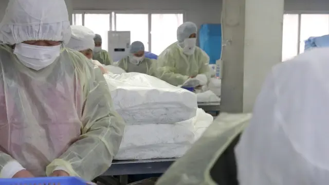 Varios trabajadores, en una fábrica de mascarillas en la ciudad china de Nantong.
