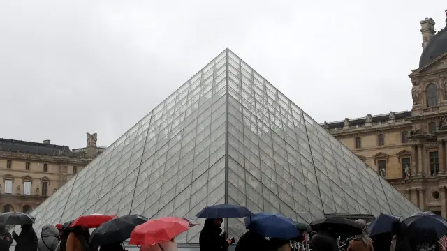 People line up at the Louvre Museum as the staff closed the museum during a staff meeting about the coronavirus outbreak, in Paris