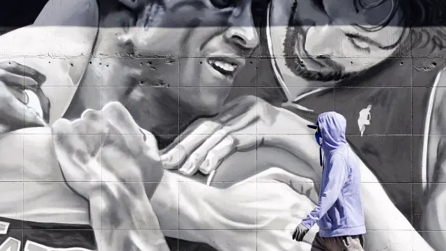 Un viandante pasa por delante del mural que refleja a los jugadores Pau Gasol y Kobe Bryant, en Los Angeles.