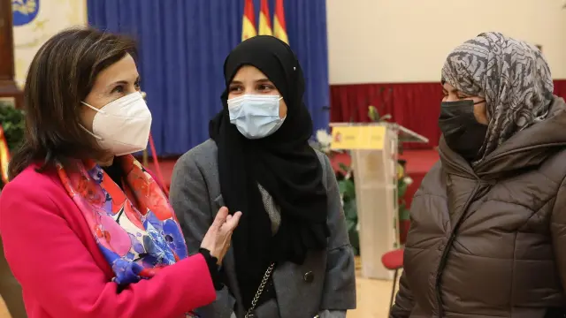 La ministra de Defensa, Margarita Robles, saluda a Samia, Marian y Sami, una familia que vino a España procedente de Afganistán.