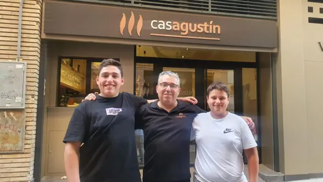 Antonio Miguel Serón, propietario de Casa Agustín, con sus hijos Agustín y David en la puerta del nuevo restaurante abierto en Zaragoza.