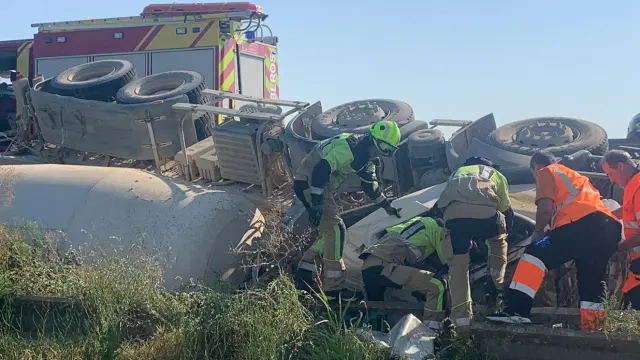 Labores de rescate de un conductor atrapado tras el vuelco de un camión en la A-131, en Lalueza.