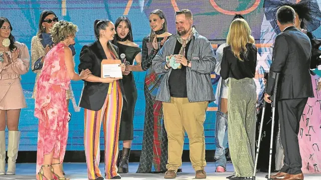 La presentadora Adriana Oliveros (izquierda) y la diseñadora Paloma Suárez animan a un emocionado Álvaro Castillo nada más desvelarse el veredicto del certamen.