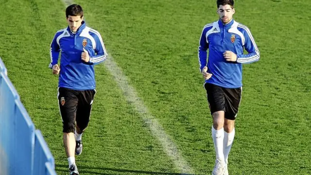 Jorge López, con nuevo peinado, y Arizmendi, ayer, mientras corrían en zapatillas por la Ciudad Deportiva al margen del grupo.