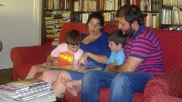 La pareja y sus dos hijos miran fotos de otros años