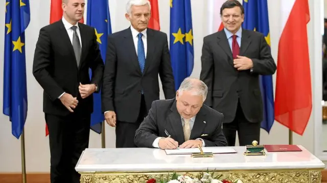Lech Kaczynski firma el Tratado de Lisboa, acompañado por Duraaao Barroso (d), Jerzy Buzek (c) y Fredrik Reinfeldt (i) ayer en Varsovia.