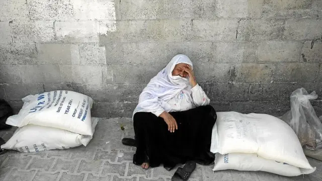 Una palestina esperaba ayer en Gaza a recibir comida de la Agencia de la ONU para los Refugiados de Palestina en Oriente Próximo.