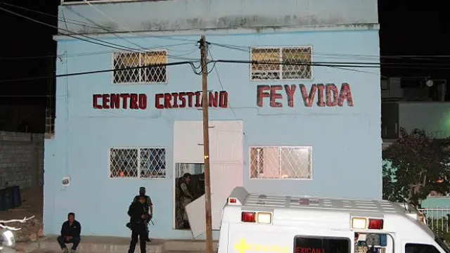 Funcionarios forenses trabajan en el centro donde sucedieron los crímenes en Chihuahua.